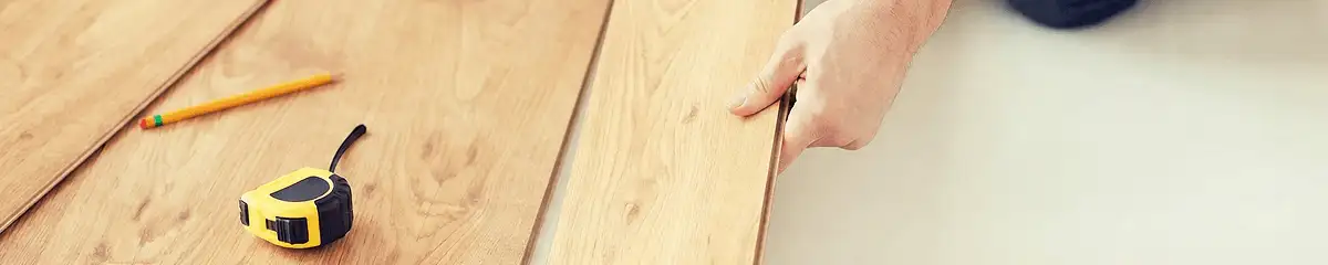 A professional installing wood flooring in Bakersfield, CA