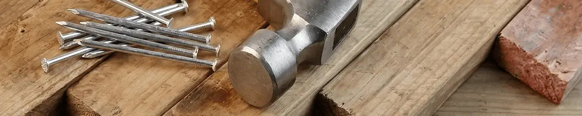 Hammer and nails on hardwood flooring boards in Bakersfield, CA