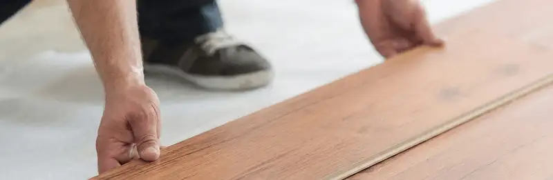 A professional installing laminate flooring in Bakersfield, CA