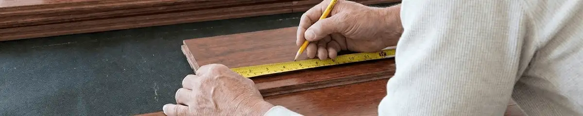 A professional installing wood flooring in Bakersfield, CA
